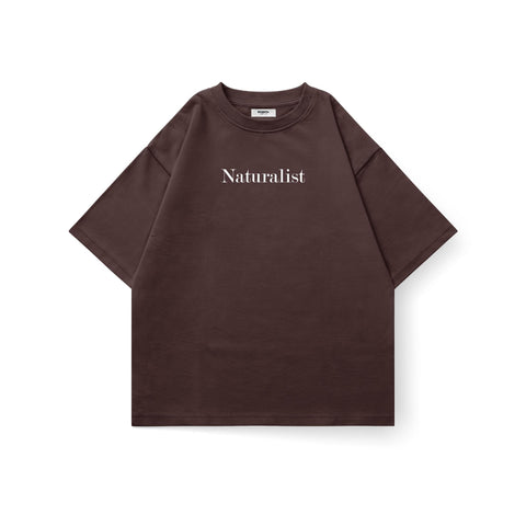 Kaihama Naturalist oversized T-shirt in soft fabric, showing relaxed fit, crew neck, and natural-inspired design on light-colored fabric.